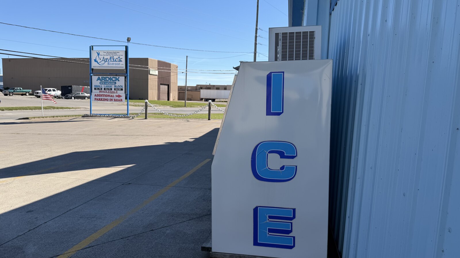 The ICE merchandiser against the side of the building at Ardick Seafood, with the road sign out by Colorado Avenue behind it